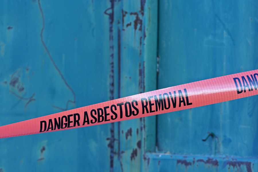 A safety tape warning of ongoing asbestos removal in a property