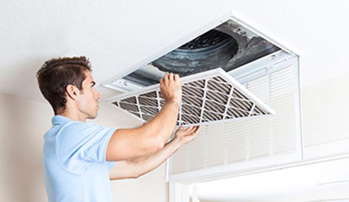 man holding filter air duct cleaning