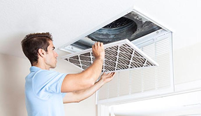 man holding air filter