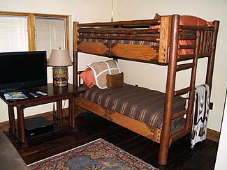 Wood bunkbeds with rustic style railings.